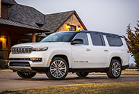 The 2023 Grand Wagoneer L Series III parked in front of a beautiful farmhouse.