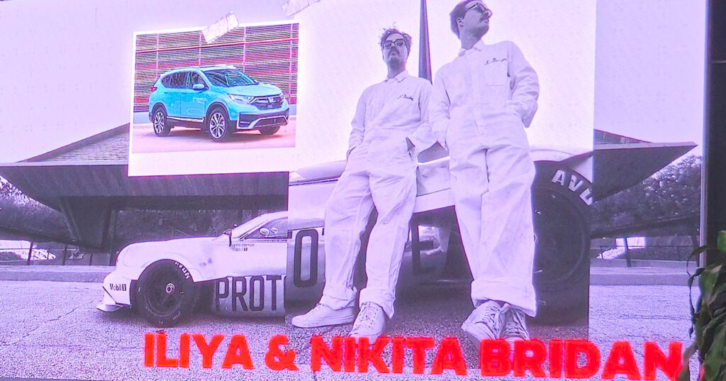 Iliya And Nikita Brydan Standing In Front Of The Half 11