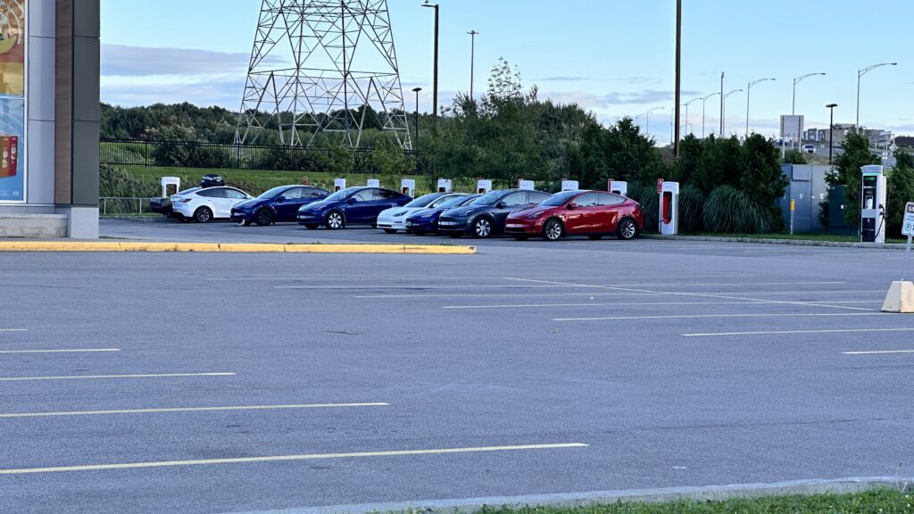 A variety of Tesla cars at a Supercharger in Quebec